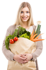 Beautiful woman carrying vegetables