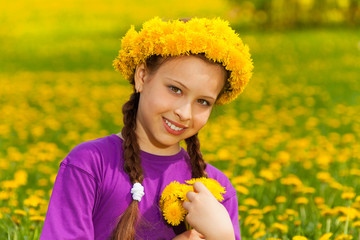 Smiling girl with dandelions
