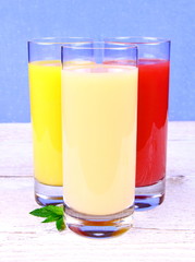 Oranges, bananas and grapefruit juice in glass