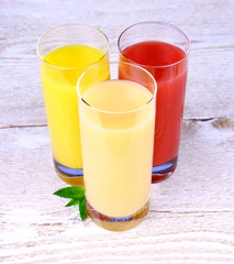 Oranges, bananas and grapefruit juice in glass