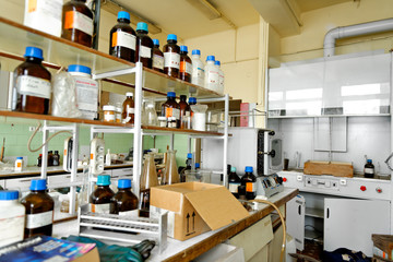 Photo of an old laboratory with a lot of bottles