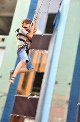 child sliding down in the urban scene