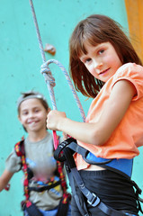 children with climbing equipment against the training wall