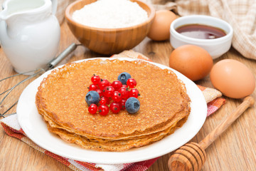 crepes with fresh berries and ingredients for baking