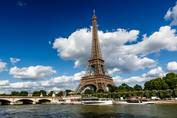 Fototapeta na wymiar Eiffel Tower and Seine River with White Clouds in Background, Pa