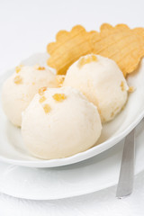 Ginger ice cream with melted milk, thin waffles close-up