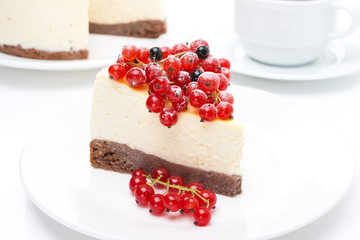 piece of cheesecake with red and black currants and coffee