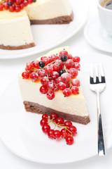 piece of cheesecake with red and black currants, vertical
