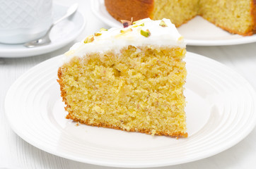 piece of orange cake with Greek yogurt, honey and pistachios
