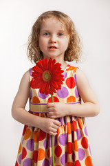 Little girl with a red flower