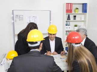 architects sitting at table and looking at a project