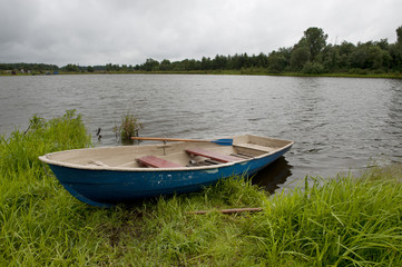 Naklejka na ściany i meble Fishing boat on the shore of Lake