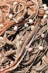 Texture of pile of fishing nets with floats. Podgora, Croatia