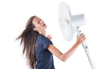 Young woman cooling herself under wind of cooler fan