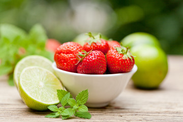 frische leckere süße erdbeeren und grüne limetten