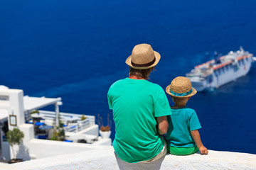 Fototapeta na wymiar father and son looking at Santorini, Greece