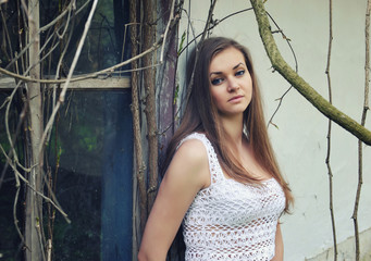 Portrait of a beautiful woman in front of abandoned old house