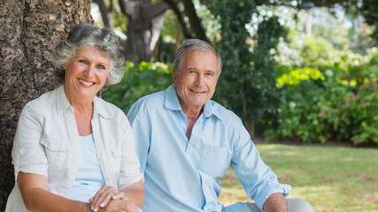 Happy mature couple smiling and looking at camera