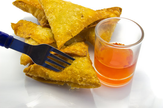 brown samoosa and Chili sauce.