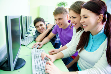 group of students studying with computer