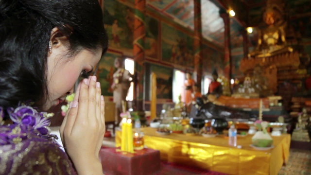 Asian girl praying in temple, wat, pagoda, Phnom Penh, Cambodia