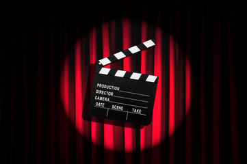 Movie clapper board against curtain