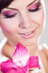 Woman Face With Pink Flowers. Perfect Skin. Professional Make-up