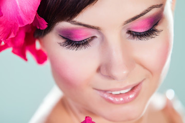 Woman Face With Pink Flowers. Perfect Skin. Professional Make-up