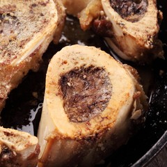 Close-up of roasted bones marrow in a pan
