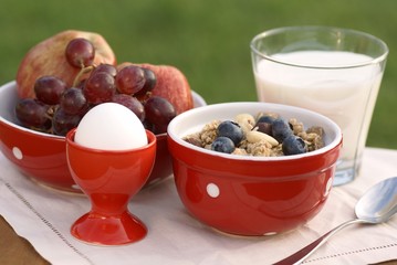 Bowl with cereal, milk, fruits and egg