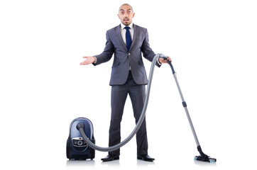 Businessman doing vacuum cleaning on white