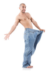 Fototapeta premium Man in dieting concept with oversized jeans
