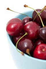 cherries in a blue cup