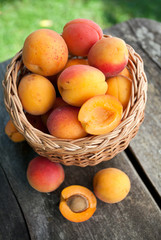 apricots in a basket on wooden background