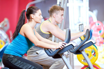 People in the gym doing cardio cycling training