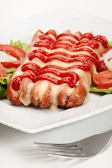 Closeup of baked sausage witch cheese