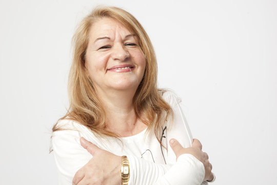 senior woman smiling over a white background