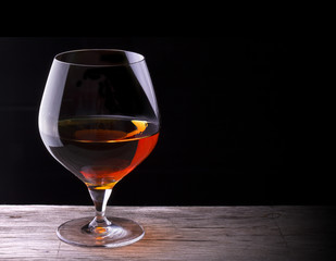 Cognac or brandy on a wooden table