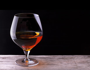 Cognac or brandy on a wooden table