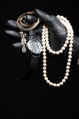 Stolen goods. Close-up of hand in gloves holding stolen goods ag