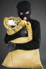 Thief with stolen goods. Front view of frustrated men in black b