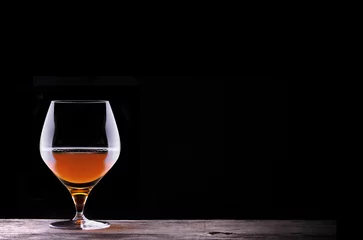 Fotobehang Cognac or brandy on a wooden table © boule1301