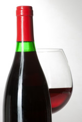 Wine bottle and a glass filled with wine isolated on white