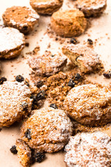 Pile of small cookies on brown paper parchament  background