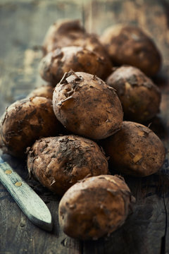 Close up of new potatoes on a wooden background