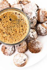 Cup of espresso and small biscotti on white