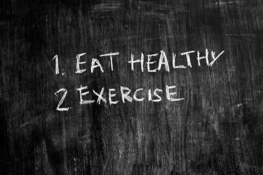 Eat healthy and exercise written on blackboard