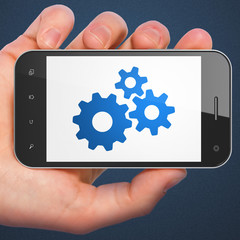Business concept: Gears on smartphone