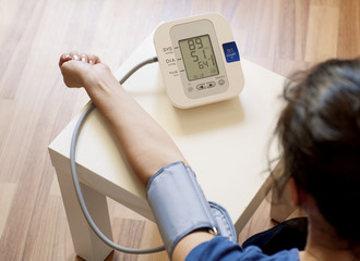 Young woman measuring her blood pressure
