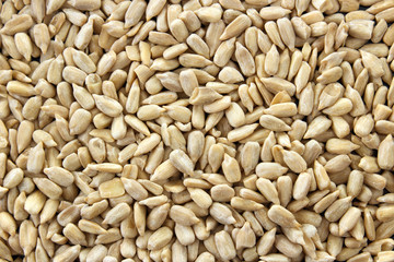Peeled edible sunflower seeds background